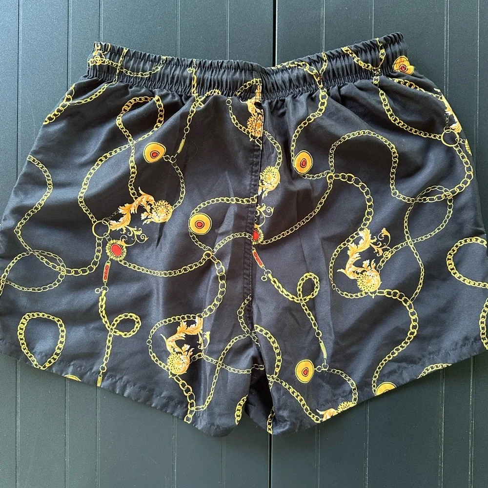 Black Men’s Swim Trunks with Gold Chain and Red Accents